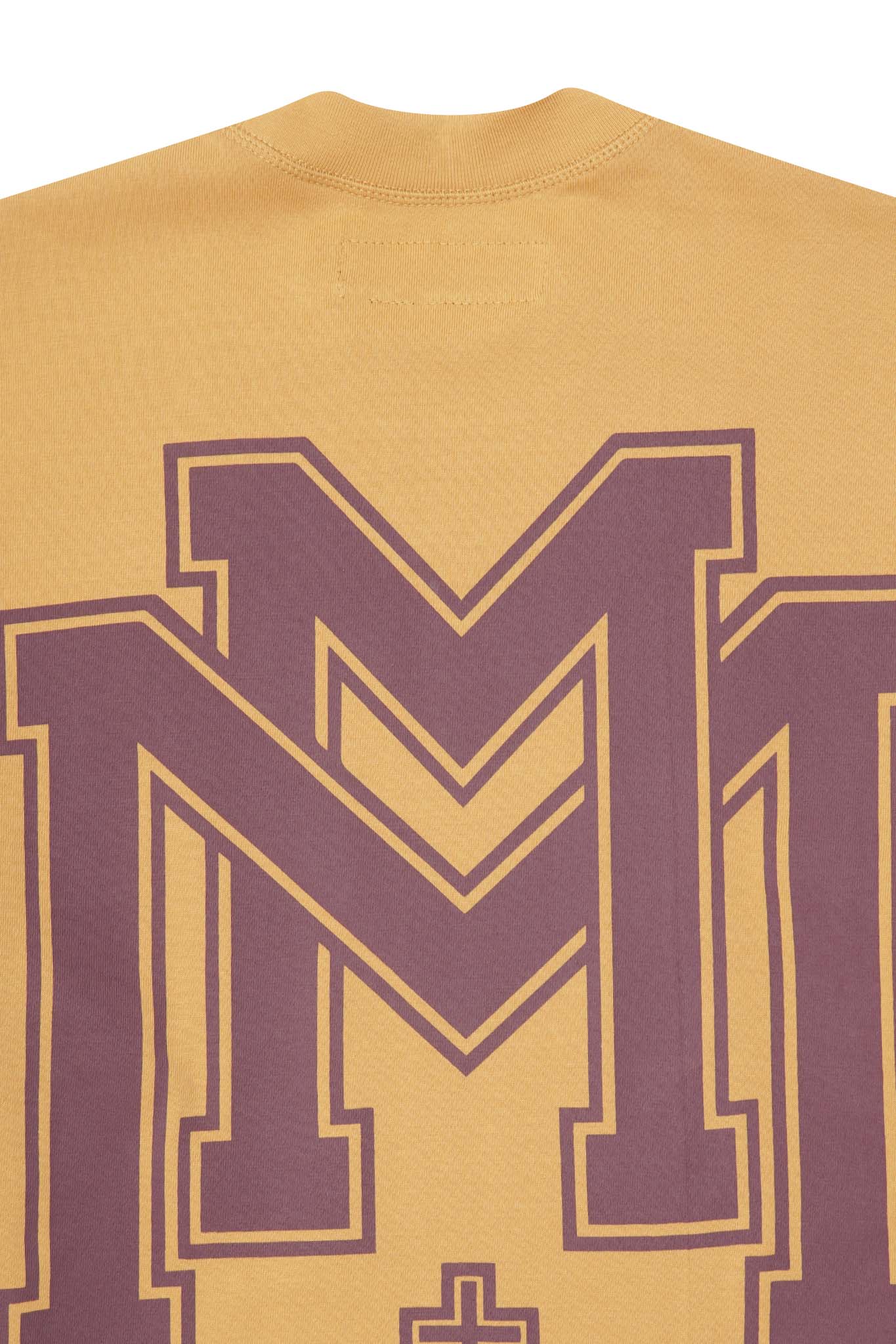 M'$ UNIVERSITY V2 TEE IN MUSTARD