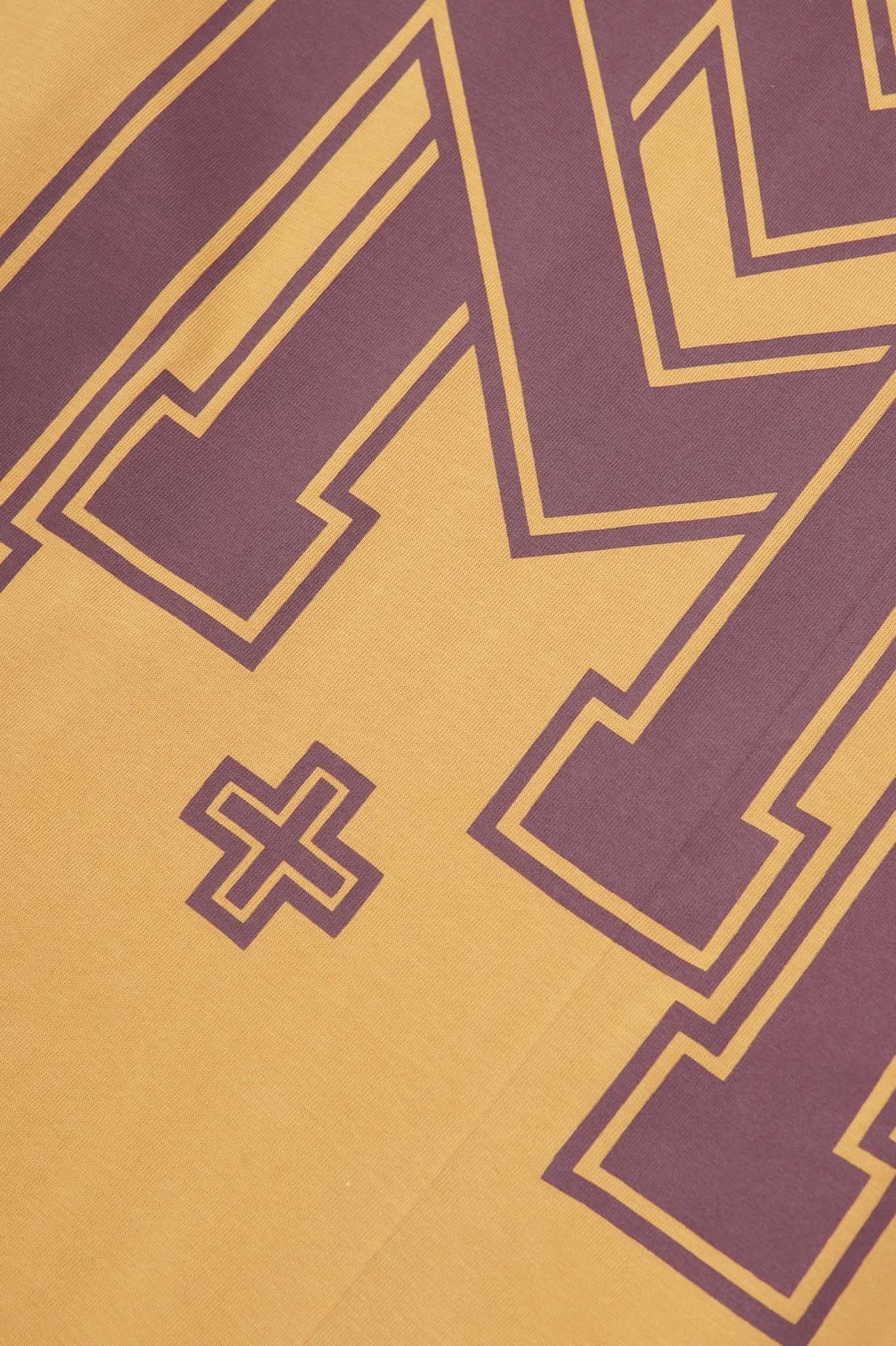 M'$ UNIVERSITY V2 TEE IN MUSTARD