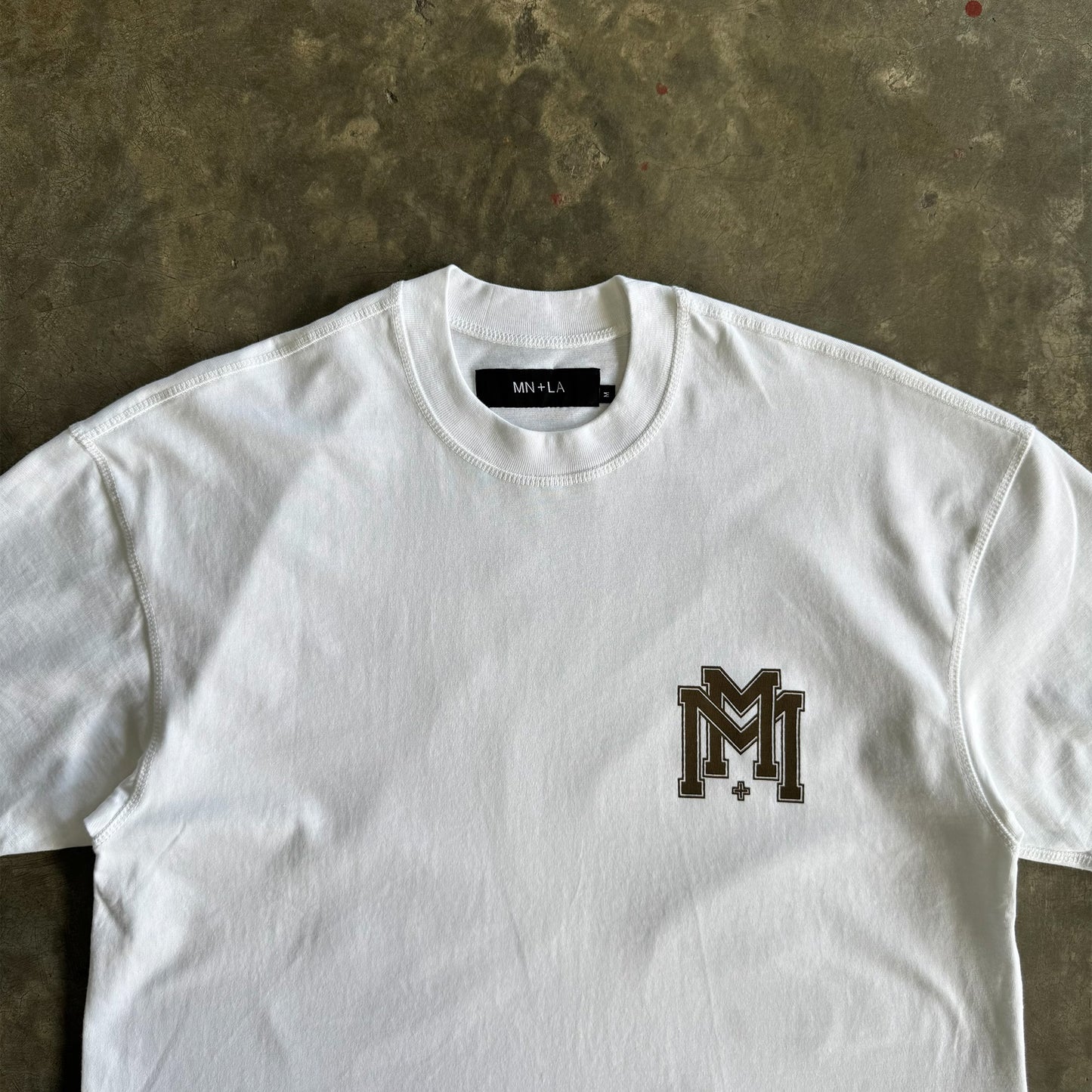 M'$ UNIVERSITY V2 TEE IN WHITE