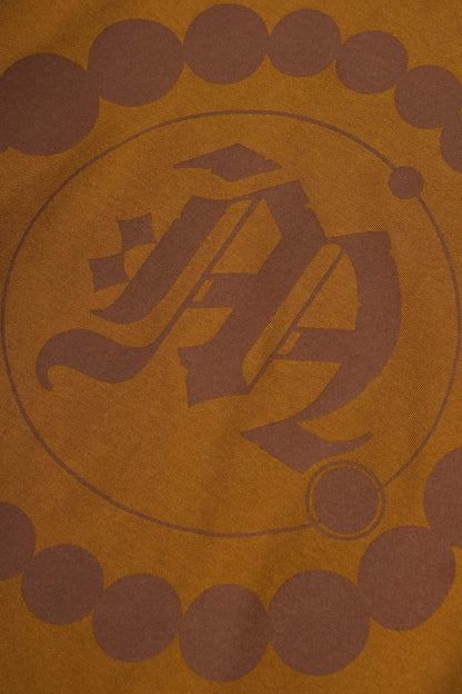 "CROP CIRCLES" MOCK NECK TEE IN RUST