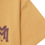 M'$ UNIVERSITY V2 TEE IN MUSTARD