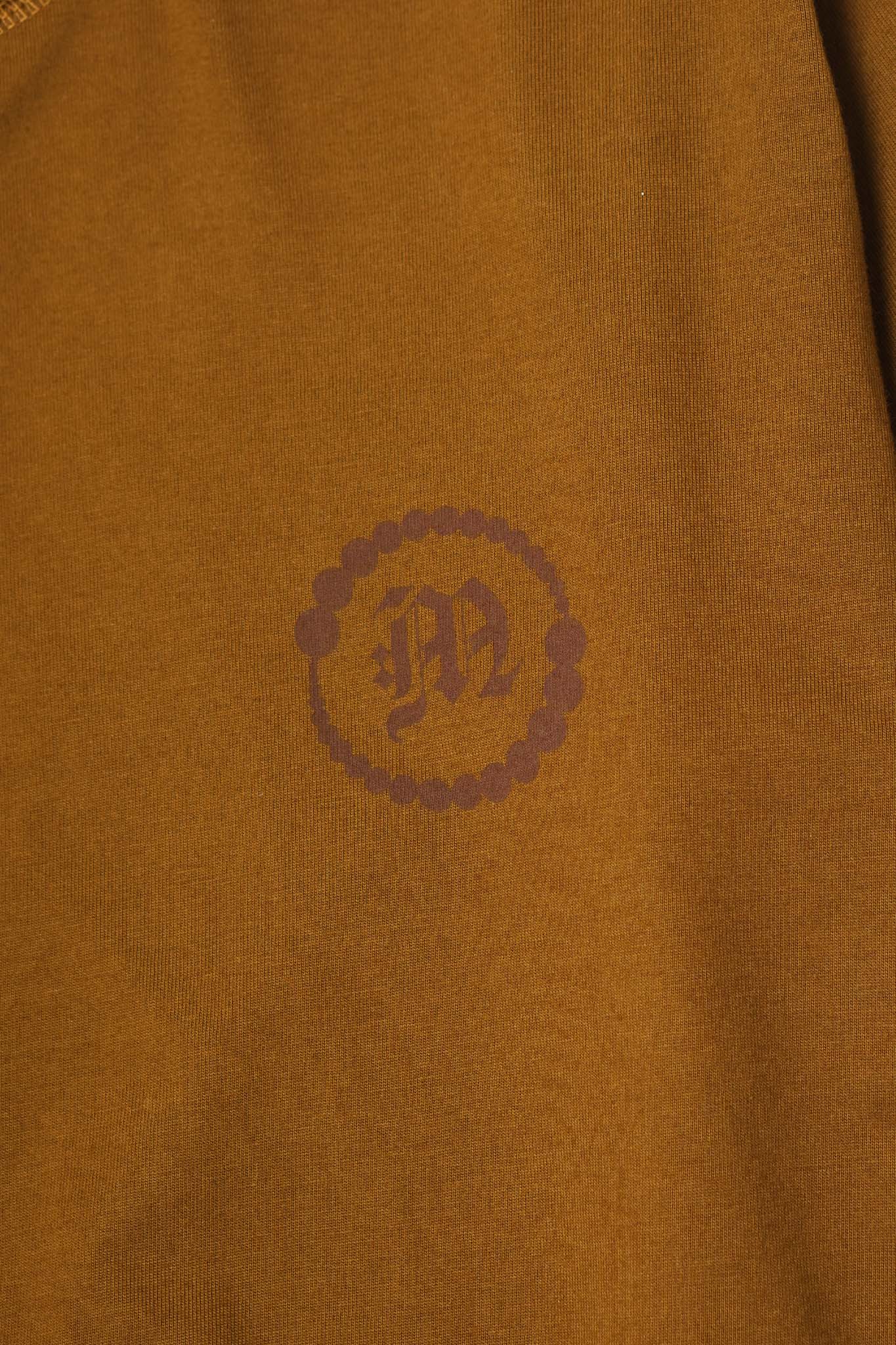 "CROP CIRCLES" MOCK NECK TEE IN RUST