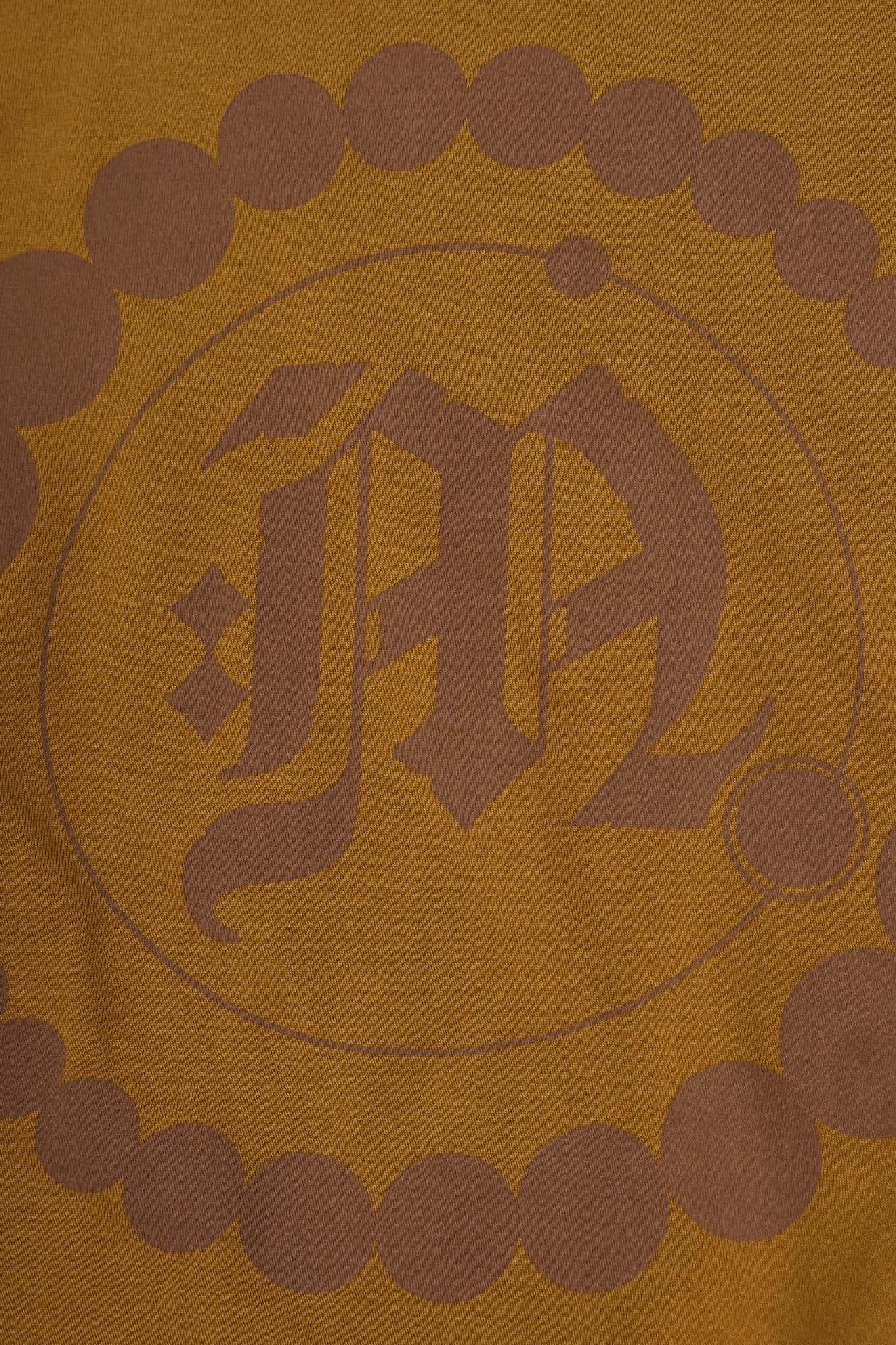 "CROP CIRCLES" MOCK NECK TEE IN RUST