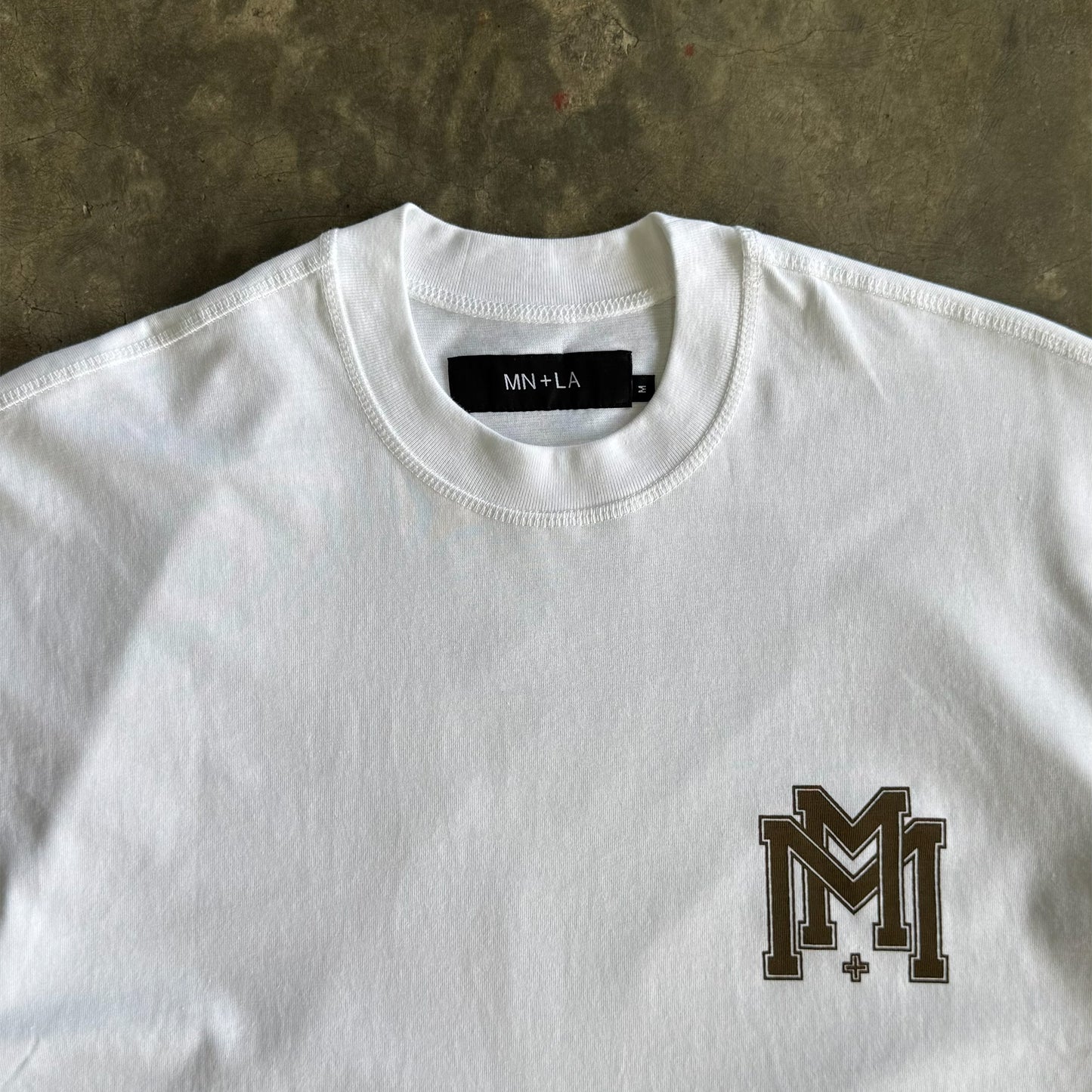M'$ UNIVERSITY V2 TEE IN WHITE