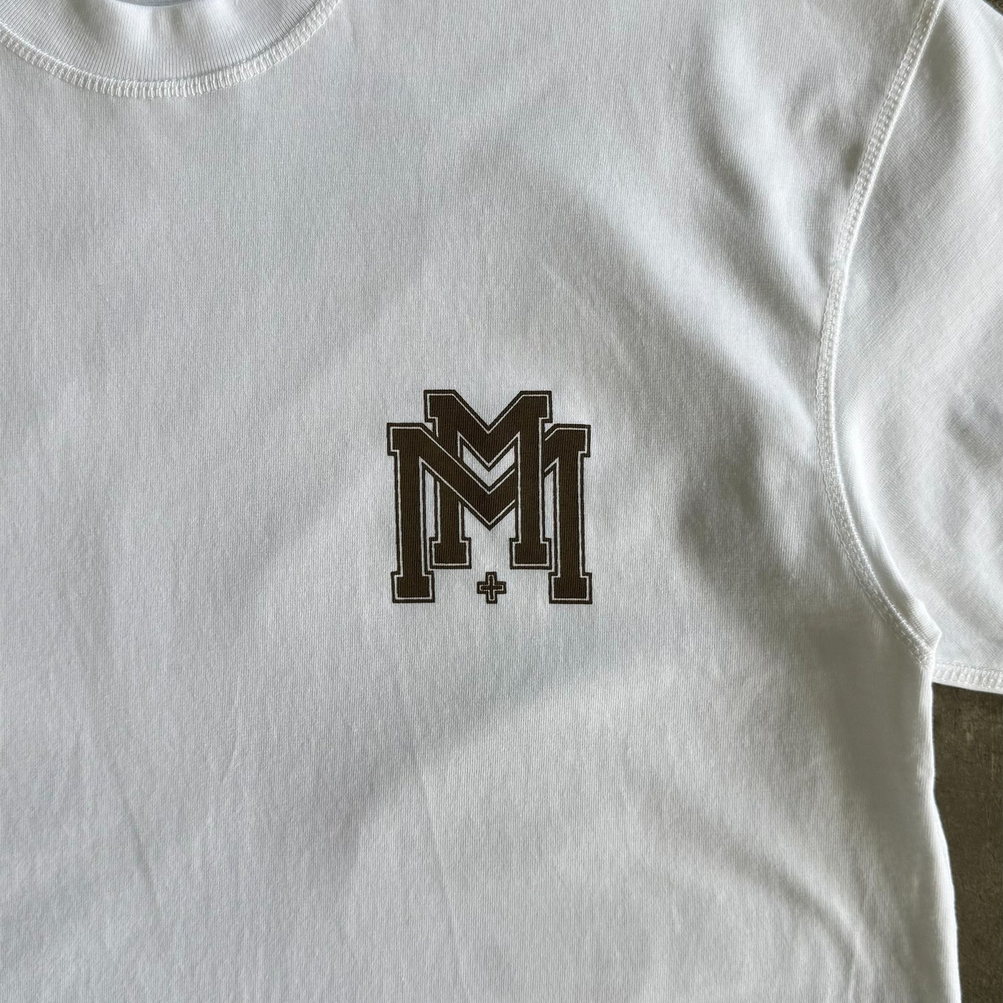 M'$ UNIVERSITY V2 TEE IN WHITE