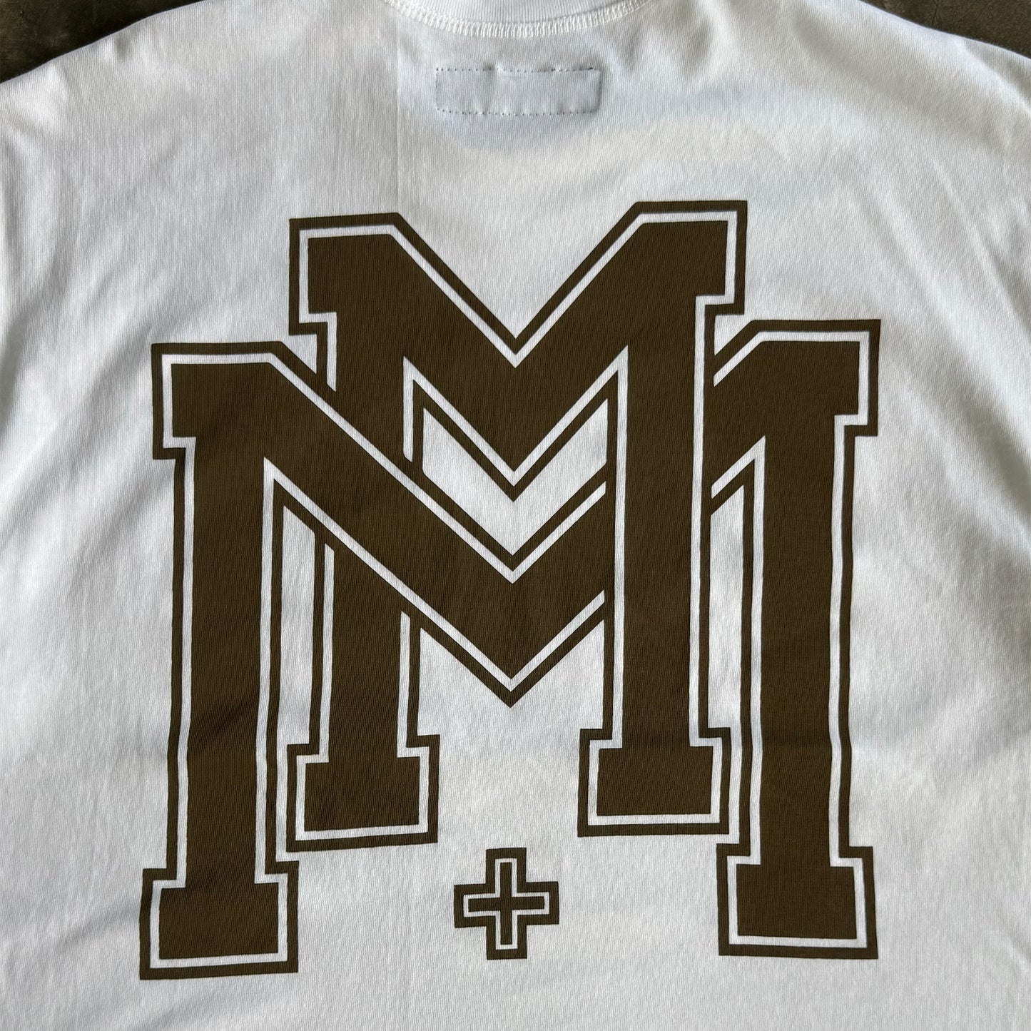 M'$ UNIVERSITY V2 TEE IN WHITE