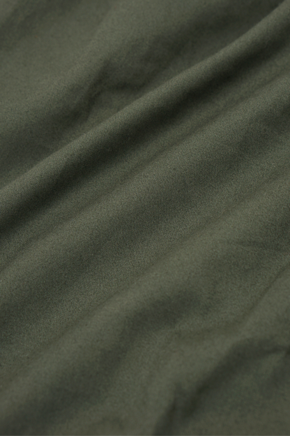 PLEATED HOUSE SHORTS IN MOSS GREEN