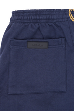 "M'$ & BEYOND" TRACK PANTS IN NAVY BLUE