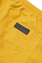 LINEN PLEATED HOUSE SHORTS IN MUSTARD
